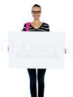 Teenager presenting white blank billboard