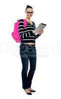 Smiling college girl using tablet pc