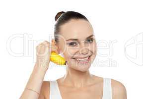Girl doing call gesture using banana as cellphone