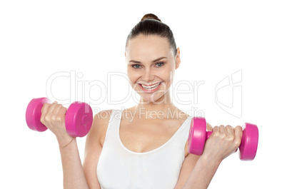 Attractive athlete exercising with dumbbells