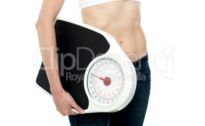 Closeup shot, woman carrying weighing machine