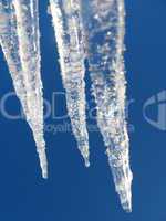 Icicles on a background of the blue sky
