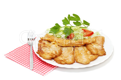 Fried fish fillets with  salad.