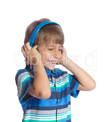 The boy listens to music on headphones. Isolate on white.