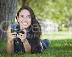 Mixed Race Young Female Texting on Cell Phone Outside