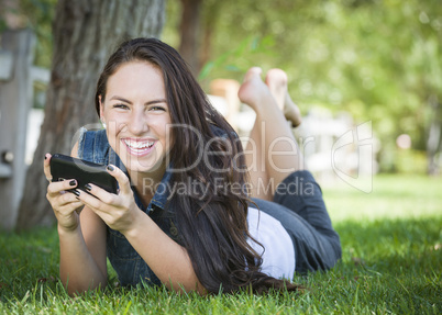 Mixed Race Young Female Texting on Cell Phone Outside