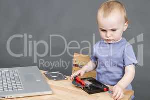 child working at open hard drive