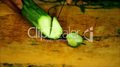 Chopping zucchini.
