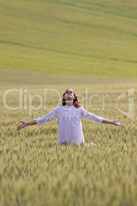 Faithful man in a field with outstretched arms