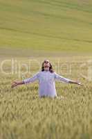 Faithful man in a field with outstretched arms