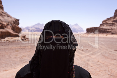 Portrait of Bedouin woman with burka in desert