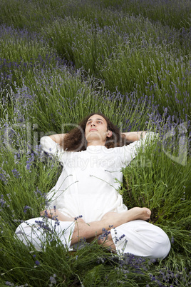 Young man relaxing in a field of lavender