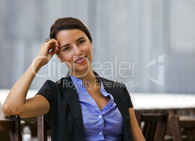 Pretty and young woman sitting outdoor