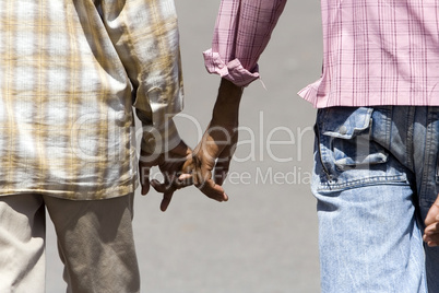 Two boys walking hand in hand