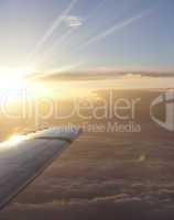 Sunbeam above wing of an airplane with Romantic sky