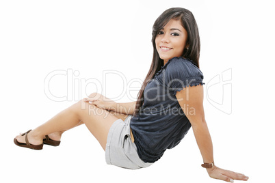 Attractive young girl sitting on the floor. All on white backgro
