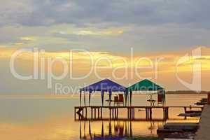 Tents above sea water at sunset