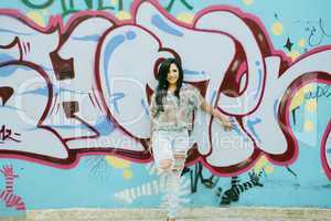 Girl against grafitti wall