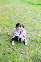 Little girl sitting in the grass - Family life