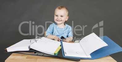 baby with paperwork at wooden desk
