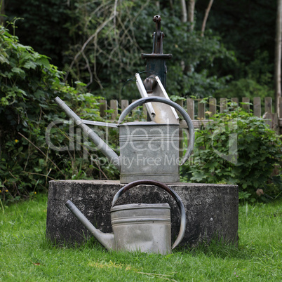 Alter Brunnen mit Gießkannen