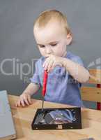 young child working at open hard drive