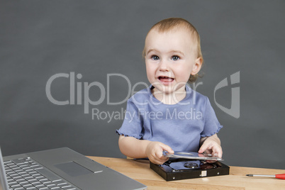 child working at open hard drive