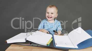 child with paperwork at desk