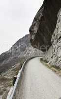 rock hanging over road