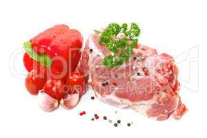 Raw meat with vegetables and spices on a white background
