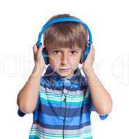The boy listens to music on headphones. Isolate on white.
