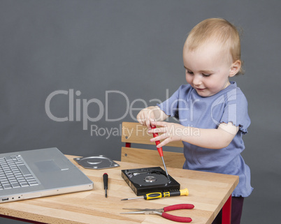 child working at open hard drive