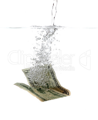 Dollar banknote in water and bubbles