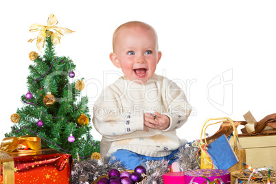 Laughing baby surrounded by Christmas gifts