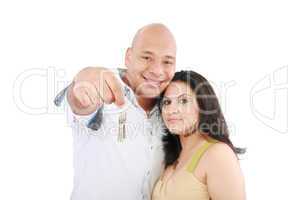 Young smiling couple holding keys of their new house