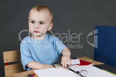 young child at small desk