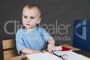 young child at small desk