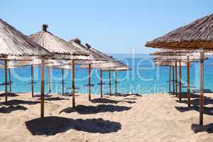 Umbrellas on a beach and turquoise water at the luxury hotel, Ha