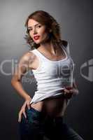Beauty woman posing jeans and white tank top