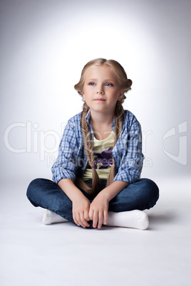 Pretty blonde girl sitting on  floor