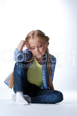 Blonde girl sitting on  floor