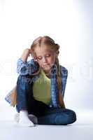 Blonde girl sitting on  floor