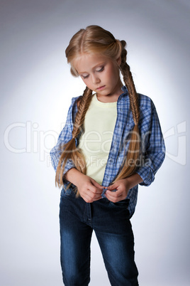 Thoughtful beautiful blonde girl in jeans