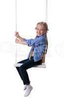 Happy blonde girl sitting on swing