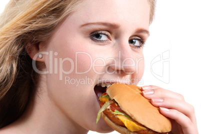 Young woman eating vegetarian burger