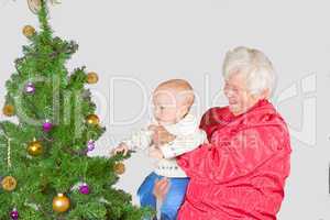 Grandmother and baby with Christmas tree