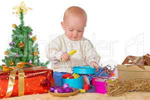 Happy baby playing with a Christmas gift