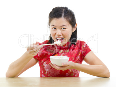 Asian woman eating rice