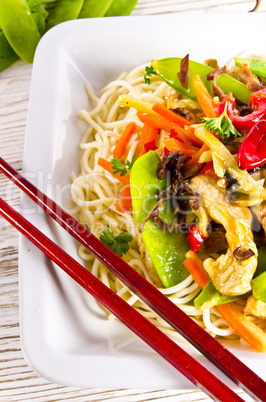 Noodles with pork and vegetables in plum sauce