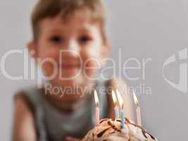 Smiling child with birthday cake candle